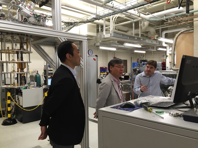 A professor gives a tour of a lab to several others