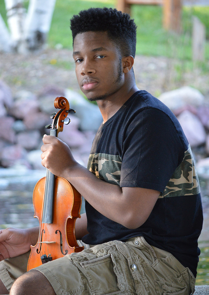 Headshot of Xzavier Herbert holding a violin