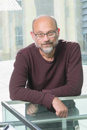 Photo of Joshua Cohen leaning on a railing