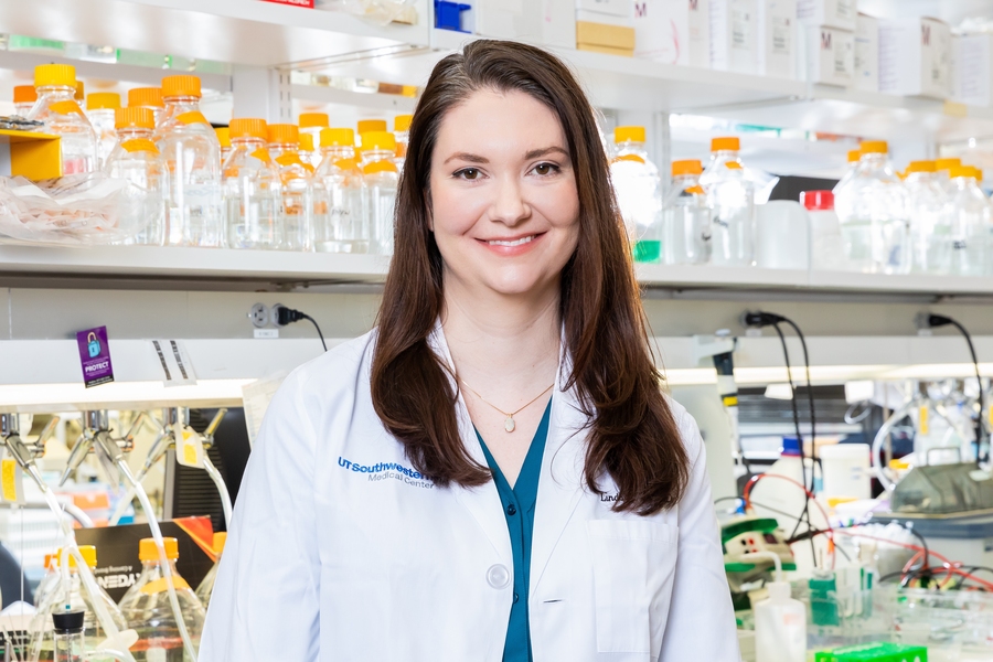 Photo of Lindsay Case standing in a lab