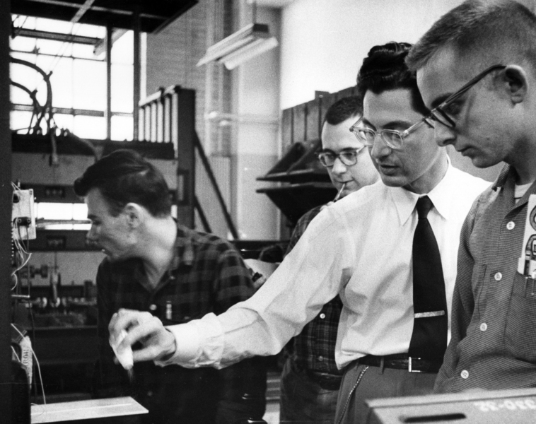 1960s-era photo of Professor Emeritus John Dugundji working with graduate students