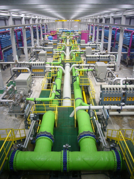 Photo taken iInside a reverse osmosis desalination plant, showing a web of colorful pipes