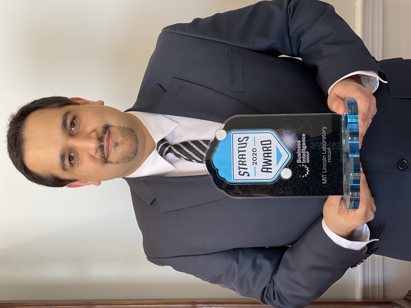 Hamed Okhravi pictured holding the STRATUS trophy