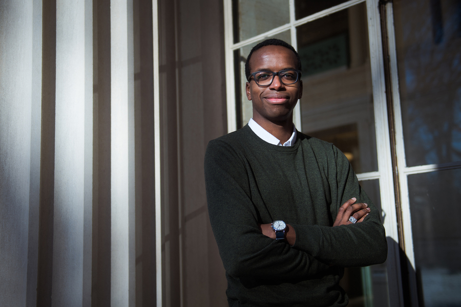 Portrait of Richard Ibekwe with his arms crossed and smiling