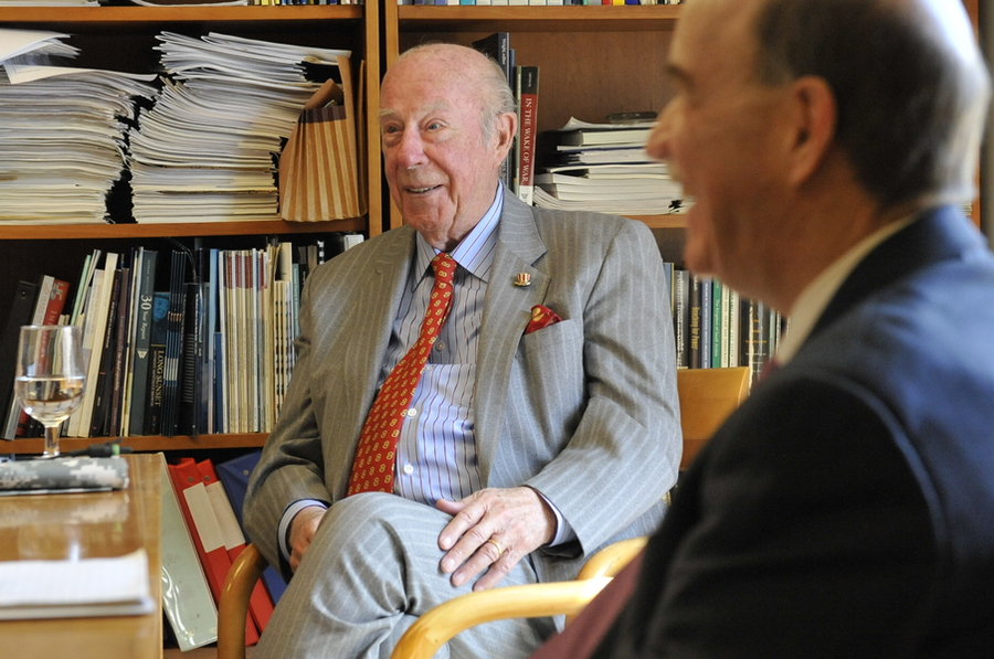 Photo of George Shultz and Robert Armstrong sitting in an office lined with books