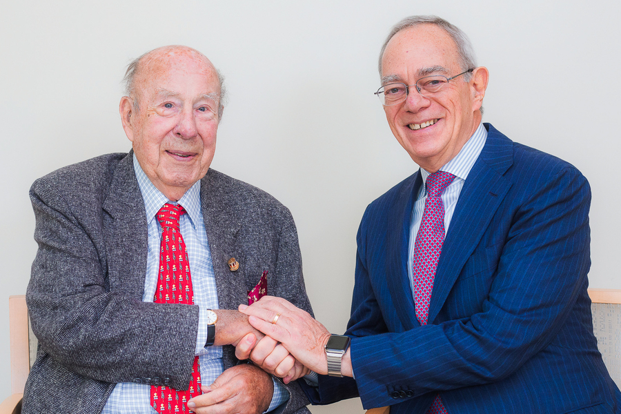 Photo of George Shultz (left) and L. Rafael Reif shaking hands