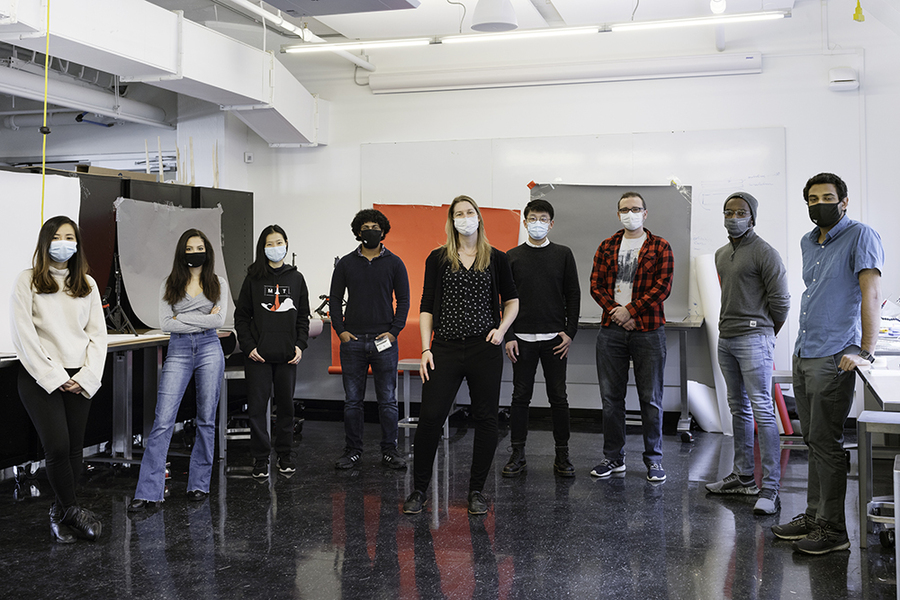 Photo of Professor Mueller and eight students standing in the lab, wearing masks and keeping distance from each other