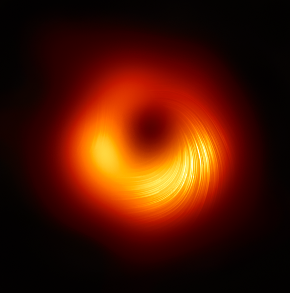 A black image features a fuzzy ring in shades of orange and yellow, with a yellow region toward the bottom featuring faint but clear spiraling lines