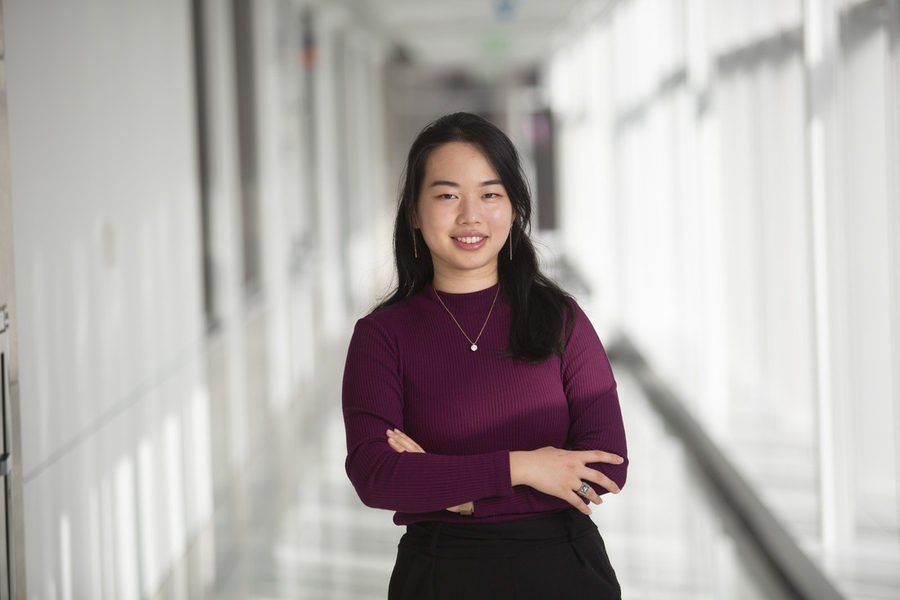 Jessica Xu standing in a corridor with her arms crossed