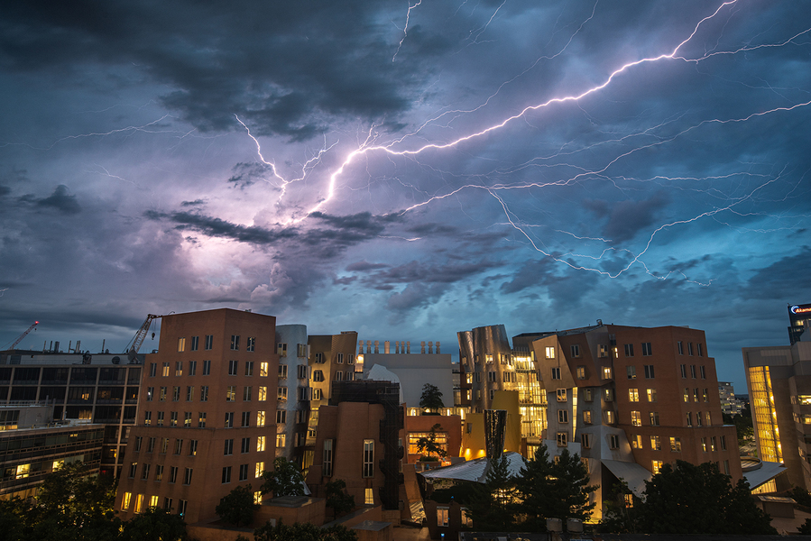 Lightning streaks across the evening sky over the MIT Stata Center