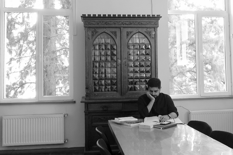 Black-and-white photo of Kochhar conducting research in a historical archive