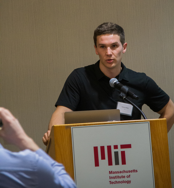 Photo of a young man standing at a podium