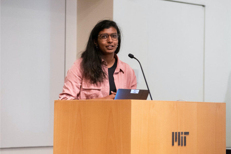 Photo of Divya Shanmugam speaking at a podium
