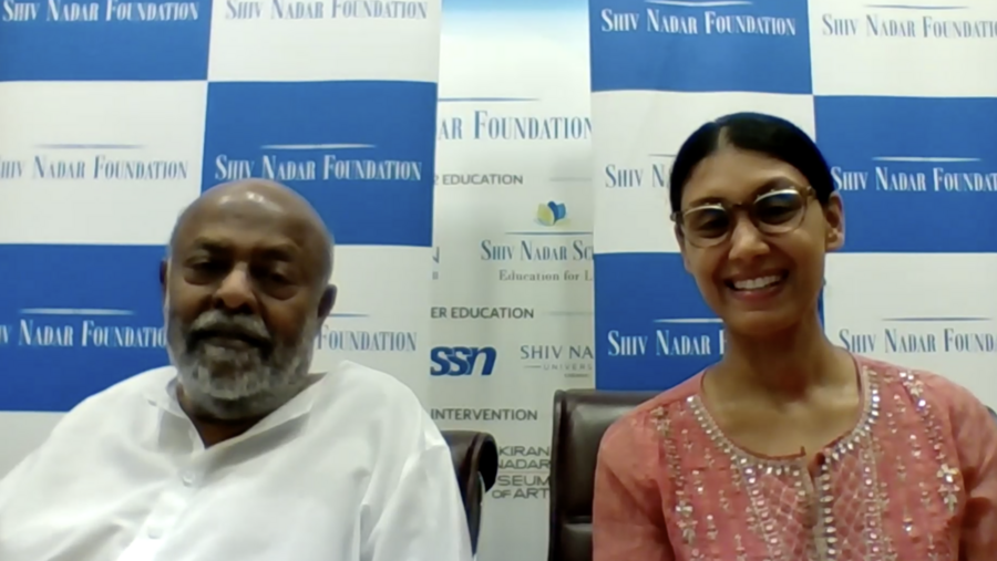 Video screengrab of Shiv Nadar (left) and Roshni Nadar Malhotra, in front of a wall with blue and white checkered rectangles that say "Shiv Nadar Foundation" on them.
