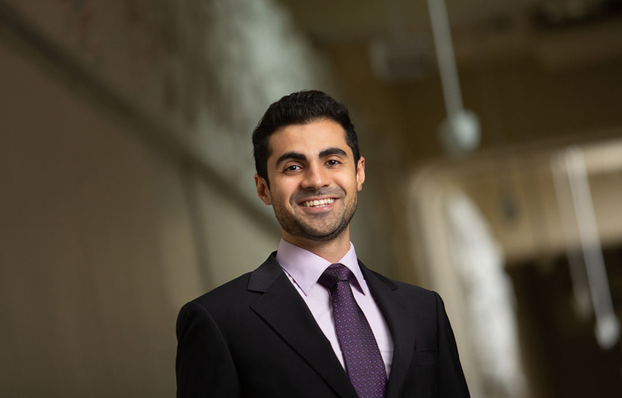 Photo of Navid Azizan standing in a hallway