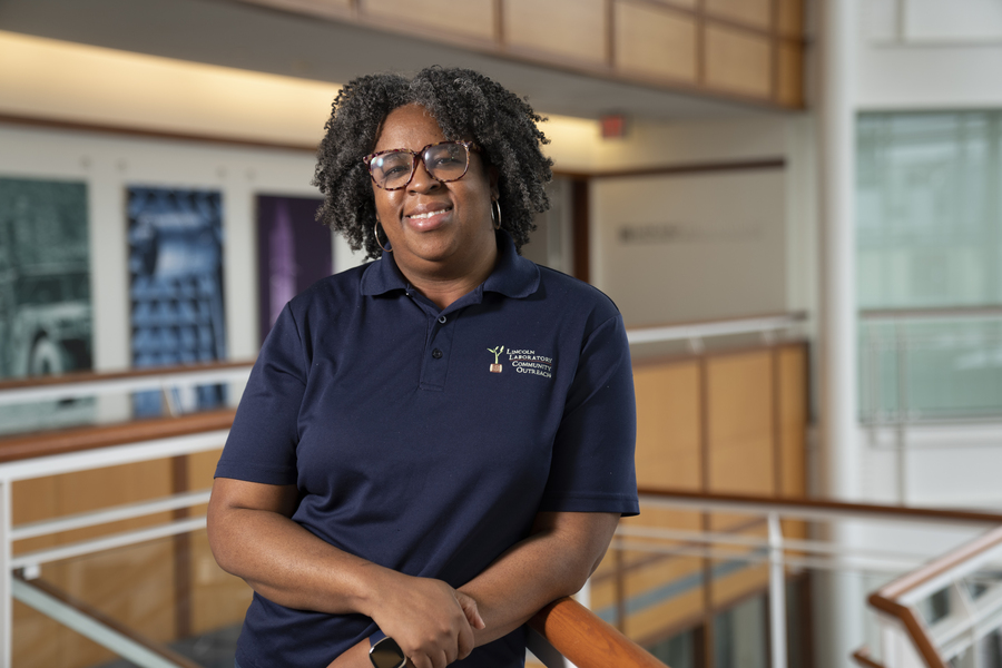 Chiamaka Agbasi Porter smiles for a photo standing in the Lincoln Laboratory lobby.
