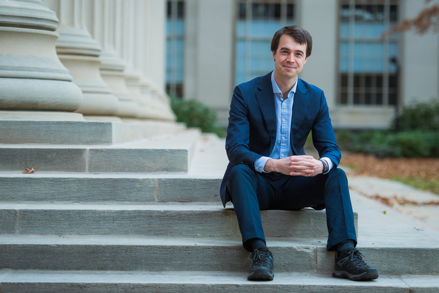 Photo of Jack Hare sitting on some steps with his hands folded