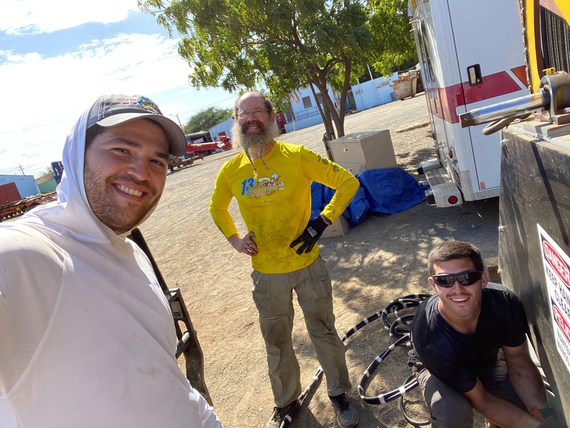 Photo of three men on shore