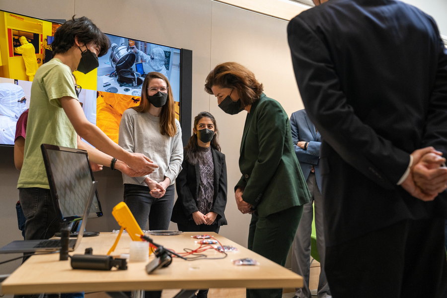 students show Gina Raimondo a solar cell