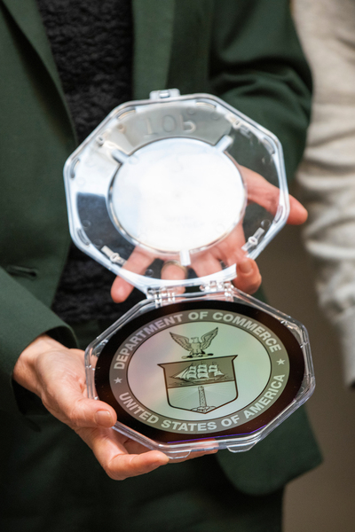 a silicon wafer reading "Department of Commerce / United States of America"