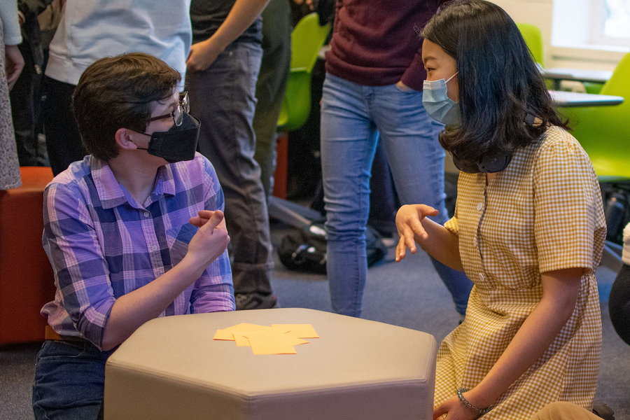 Photo of two students conversing