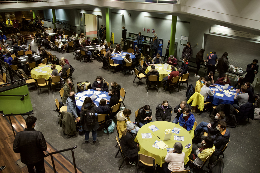MIT community members gathered together around tables in the Student Center Lobdell Dining Hall to discuss how to help with humanitarian efforts.
