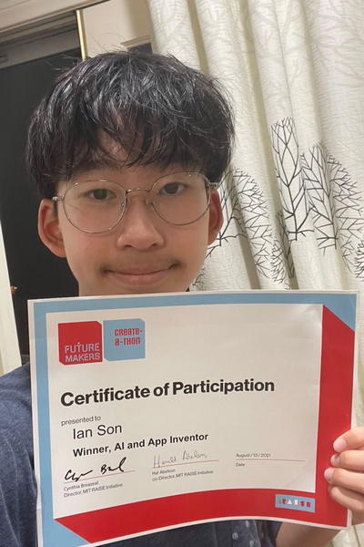 Portrait photo of teenager holding a certificate of participation
