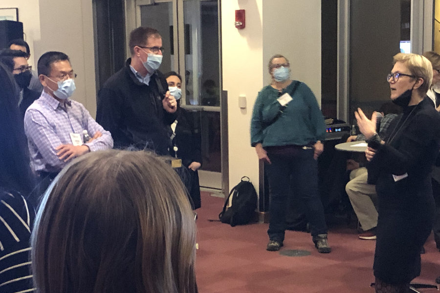Photo of Linda Griffith standing and addressing a gathering in Stata Center