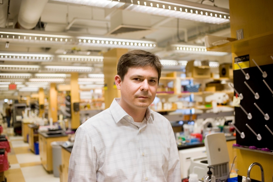 Photo of Chris Voigt standing in the lab.