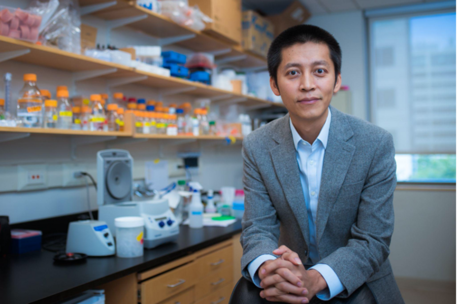 Photo of Jing-Ke Weng sitting in the lab.