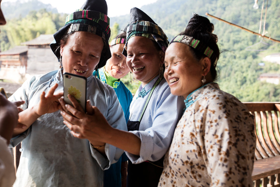 Roots studio artists looking at merchandise with their art