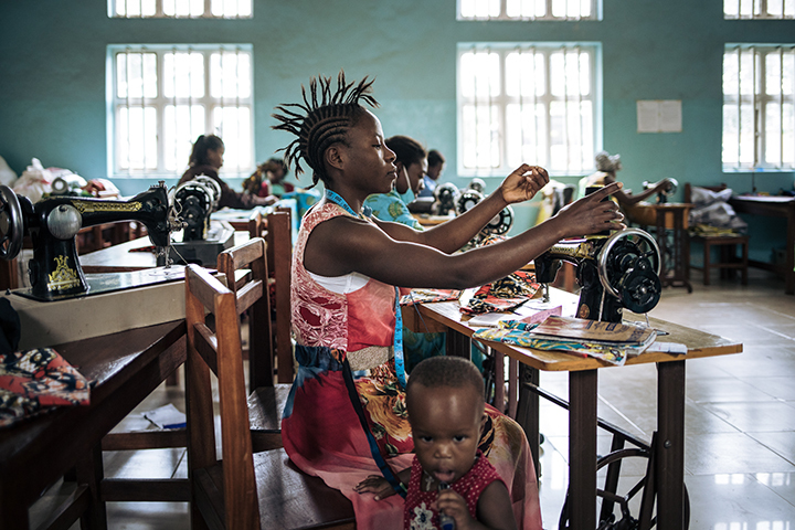 Photo of a room full of people working at sewing machines