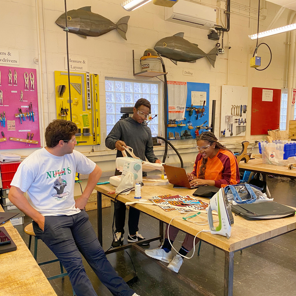 Photo of three students working in a lab