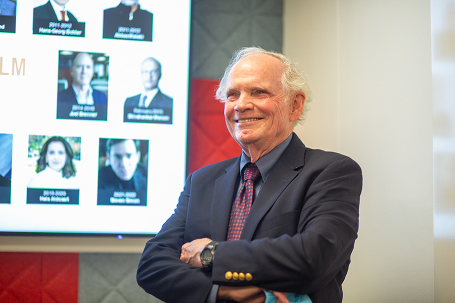 Photo of Robert E Wilhelm standing with his arms crossed