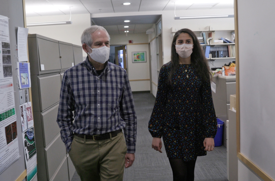 Photo of Professor Roger Kamm walking with graduate student Cynthia Hajal outside his office