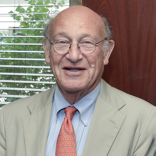 Headshot photo of Donald Bruce Montgomery in front of a window with a plant in the background