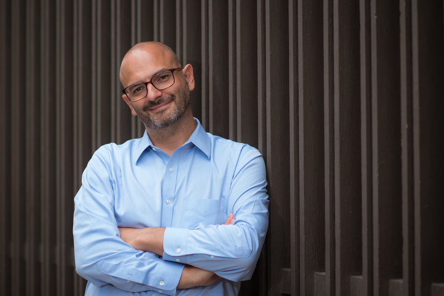 Photo of Matteo Bucci, standing with his arms folded