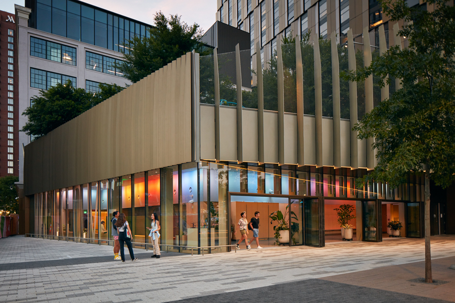 The exterior of the MIT Welcome Center glows with the colorful lighting of MIT Illuminations