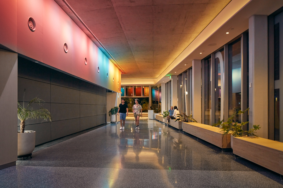 A hallway of the MIT Welcome Center is awash in a rainbow of color from the MIT Illuminations display.