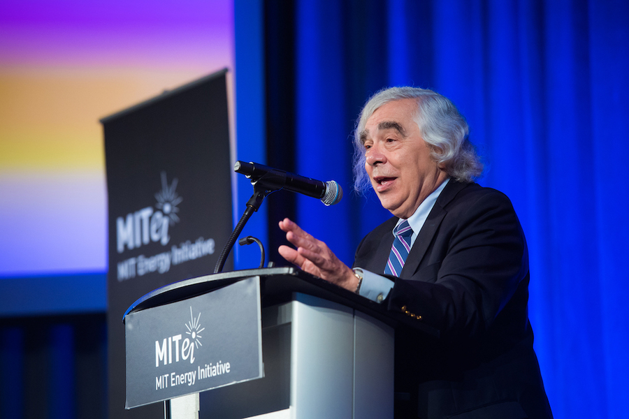 Ernest Moniz stands at a podium speaking into a microphone.