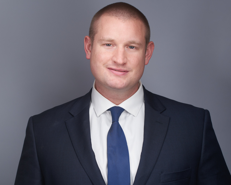 Portrait photo of Adam Petway in a suit jacket and tie