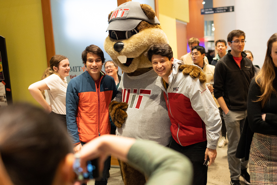 Tim the beaver poses with two community members in Stata Center