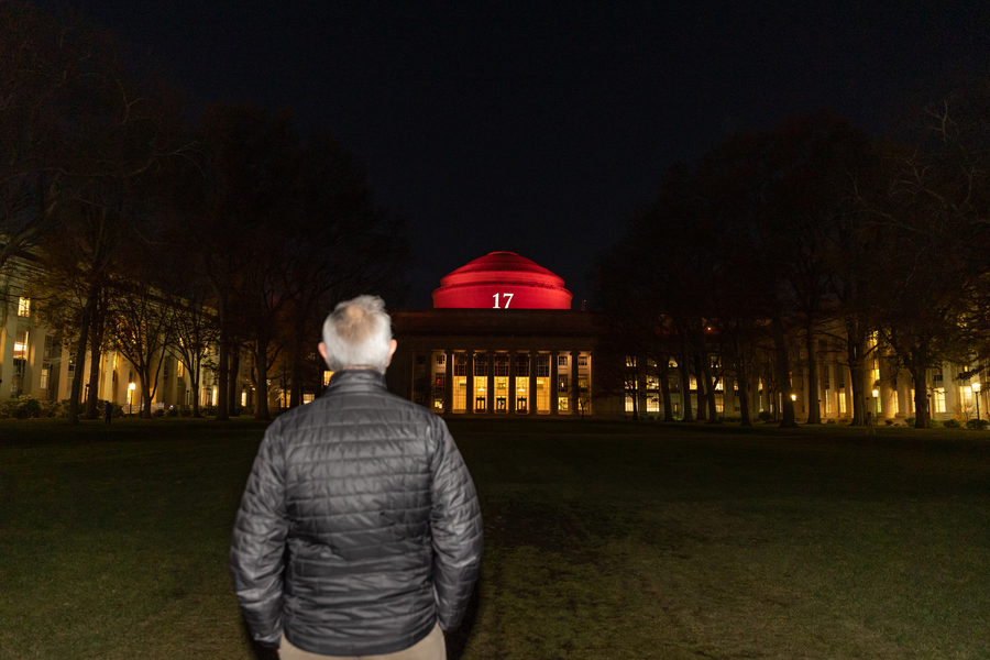 President Reif with his back to the camera facing the great dome, illluminated in red and with the nuber 17
