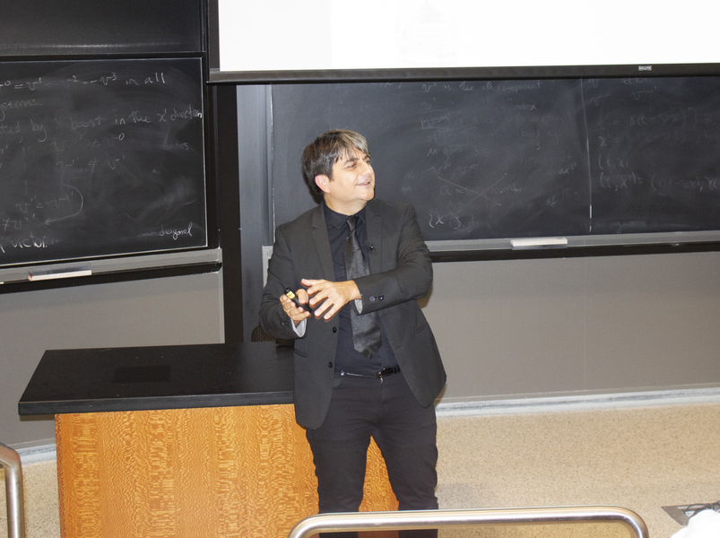 Cem Tasan gives a talk in front of a blackboard