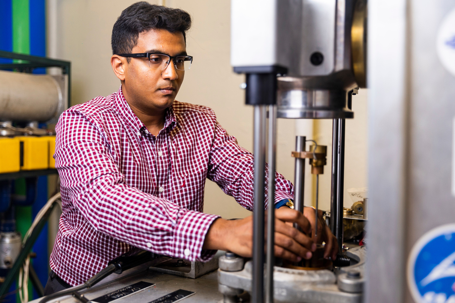 Postdoc Suhas Prameela interacts with lab equiptment.