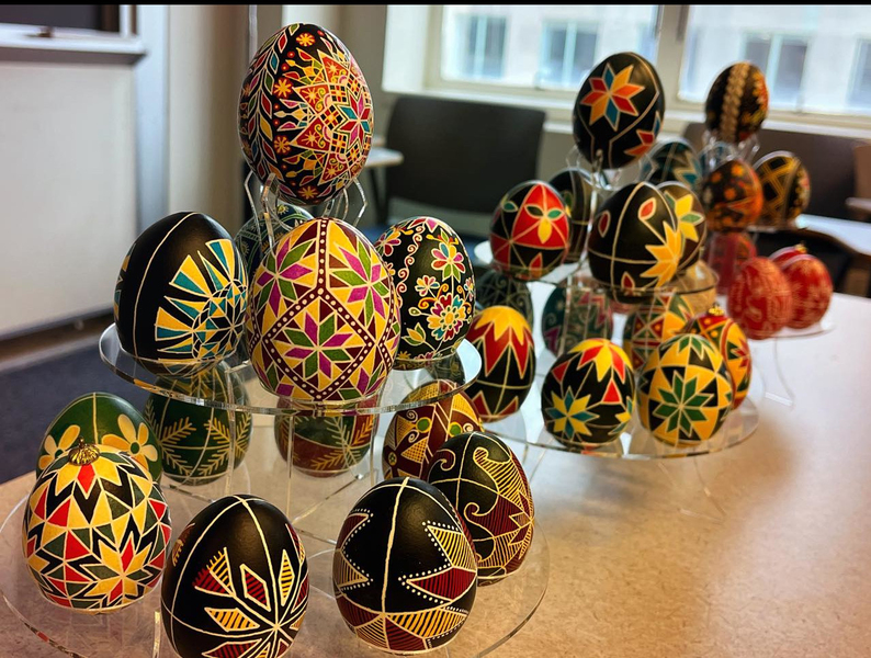 Close-up of intricately painted eggs on plastic stands
