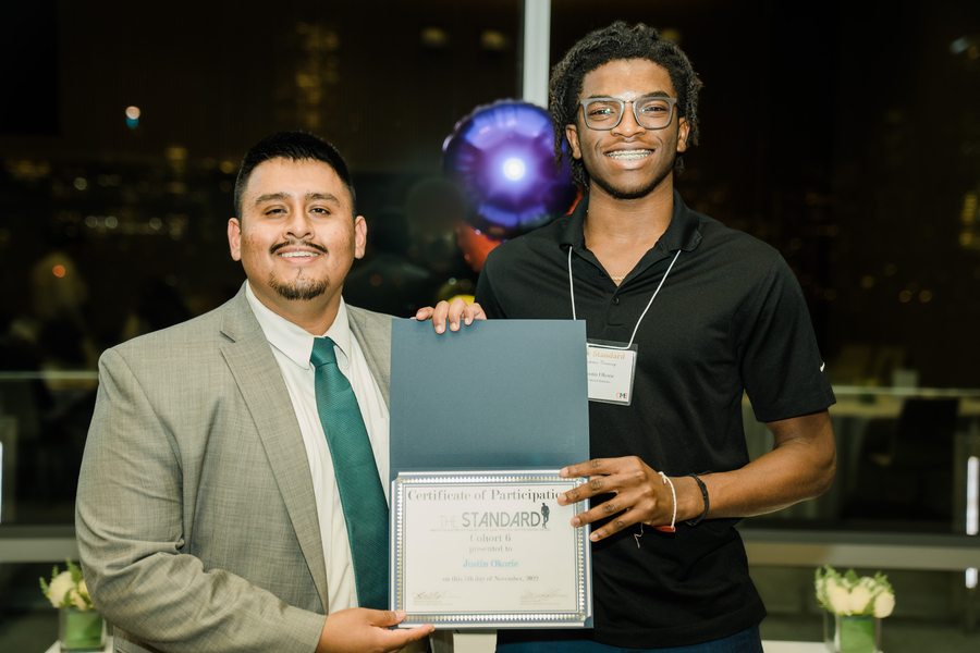 Justin Okorie poses with a certificate jointly held by an unidentified man