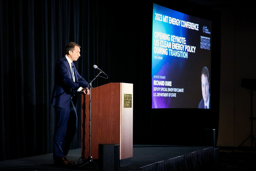Richard Duke stands at a podium with a screen in background that says, “2023 Energy Conference. Opening Keynote: US Clean Energy Policy During Transition.”