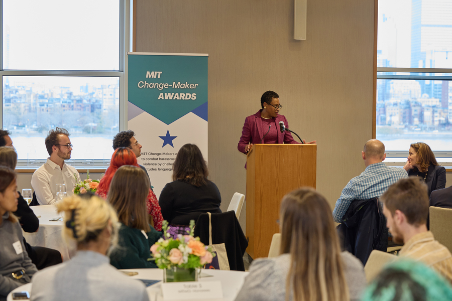 Melissa Nobles stands at a wooden lecturn at awards ceremony