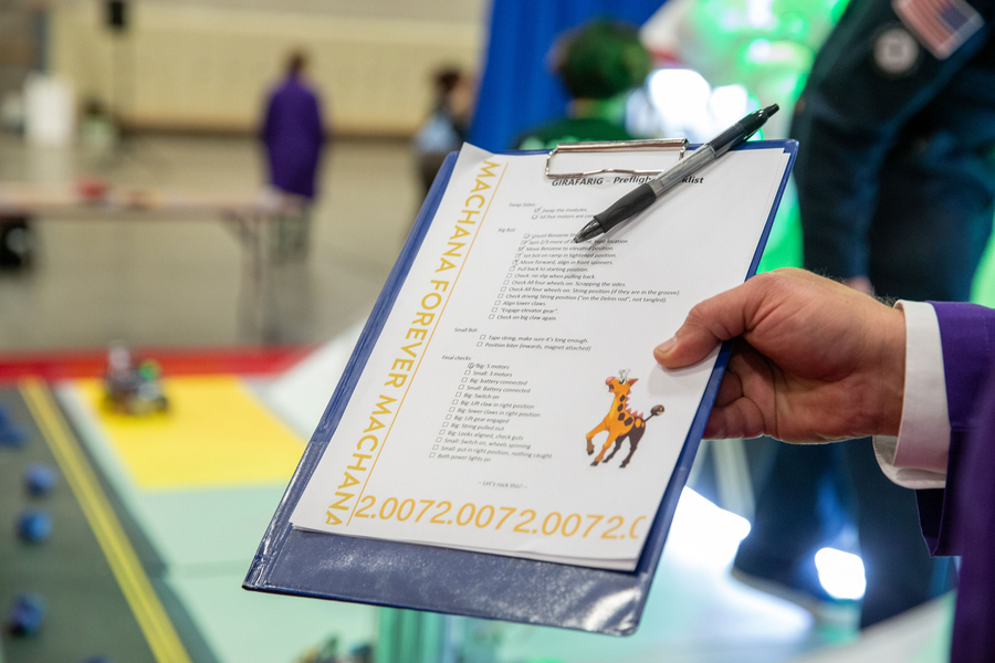 A close-up of a paper on a clip board, titled “Girafarig preflight checklist,” and decorated with a Pokemon-style illustration of a giraffe. About 20 tasks are listed, some checked off.